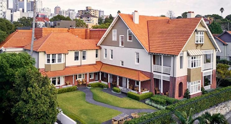 Aerial view of Lansdowne Gardens, featuring red-tiled roofs and landscaped grounds.
