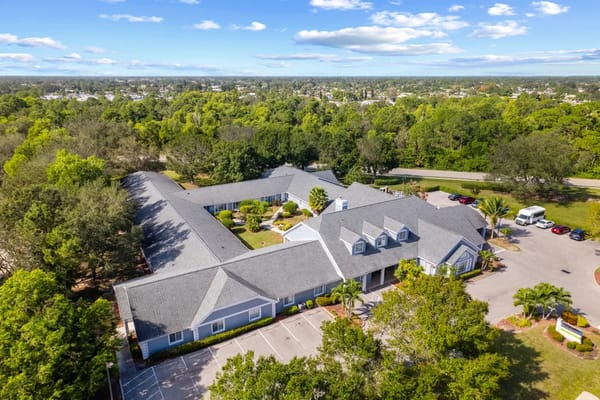 Aerial view of Lehigh Acres senior living facility surrounded by greenery