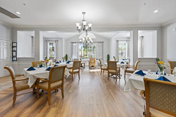 Elegant dining room with tables set for a meal.