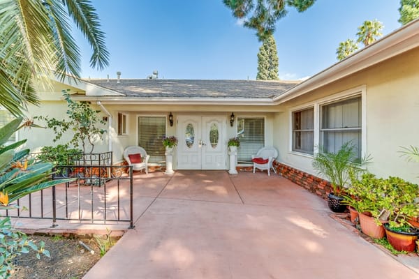 Entrance of a senior living facility with outdoor seating