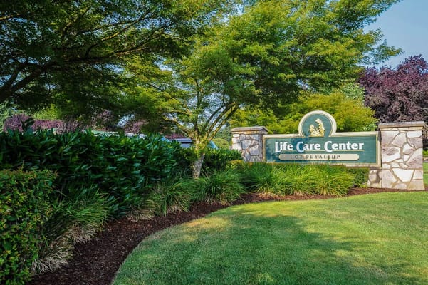 Signage for Life Care Center of Puyallup in landscaped area
