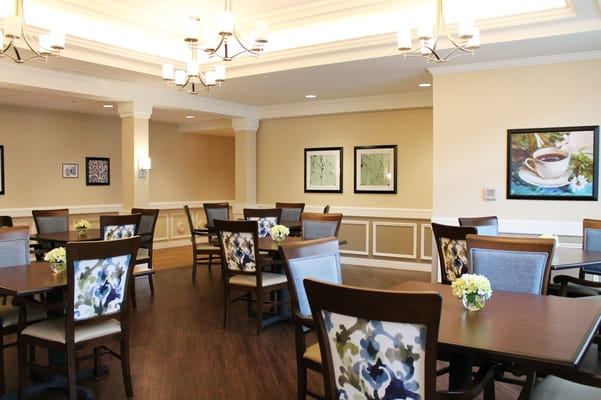 Bright dining room with tables and floral arrangements