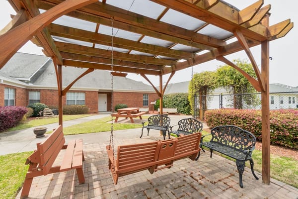 Outdoor seating area with swings and benches