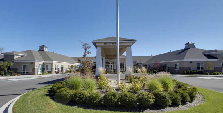 Entrance of Michigan House Senior Living surrounded by landscaping