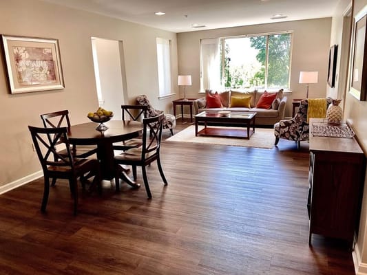 A well-decorated living room with a dining table and comfortable seating.