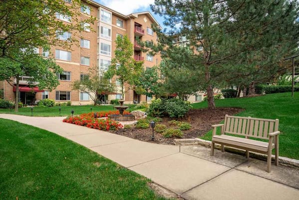 View of the garden area with a bench and flowers at Monarch Landing