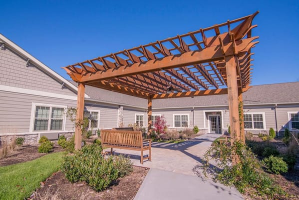 Outdoor seating area with a pergola and pathway