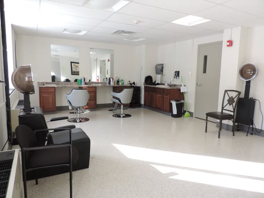Interior view of a beauty salon with chairs and mirrors