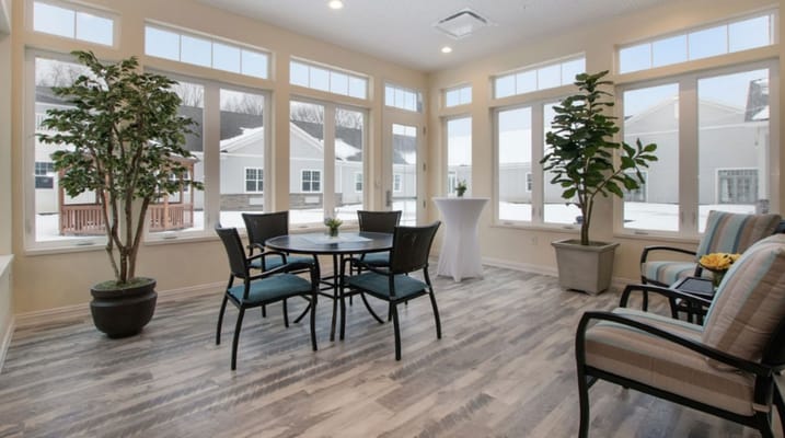 Bright communal area with seating and large windows