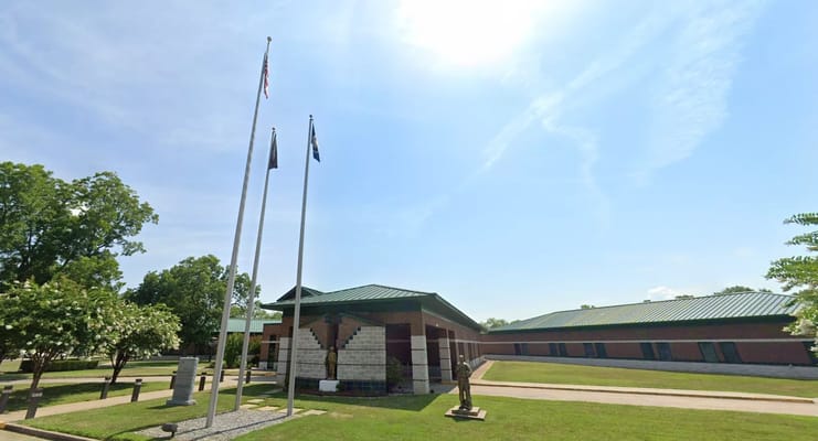 Exterior view of the Northeast Louisiana Veterans Home with flags