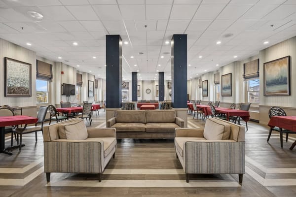 Cozy living room with couches and dining tables