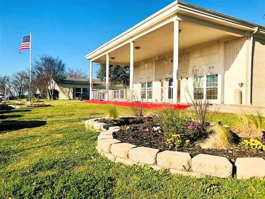 Exterior view of Park View Care Center with flower beds