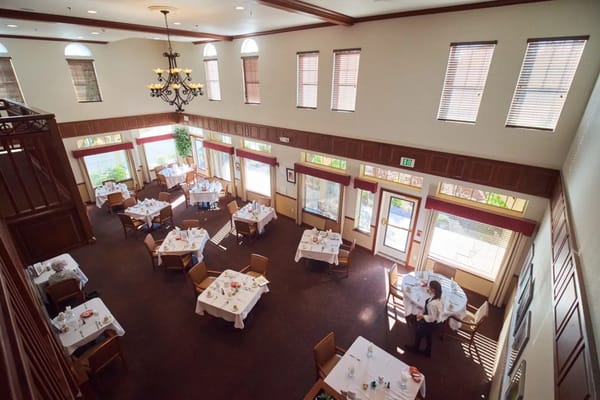 Dining room set up for meals with staff serving