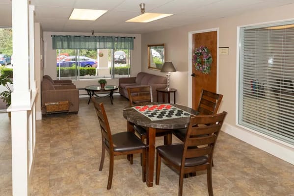 A common area in a senior living facility with seating and decor