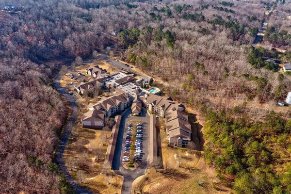 Aerial view of Regency Pointe senior living facility surrounded by wooded area