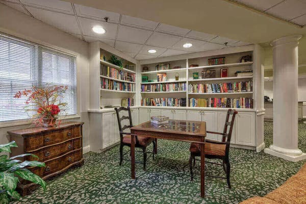 Library area with bookshelves and a wooden table