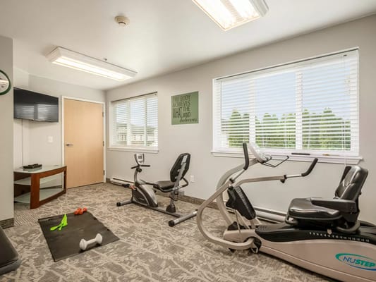 Fitness equipment in a well-lit exercise room