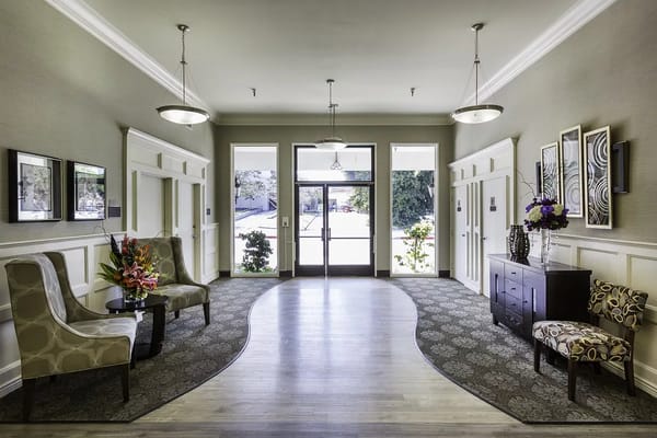 Bright lobby with seating and decorative flowers