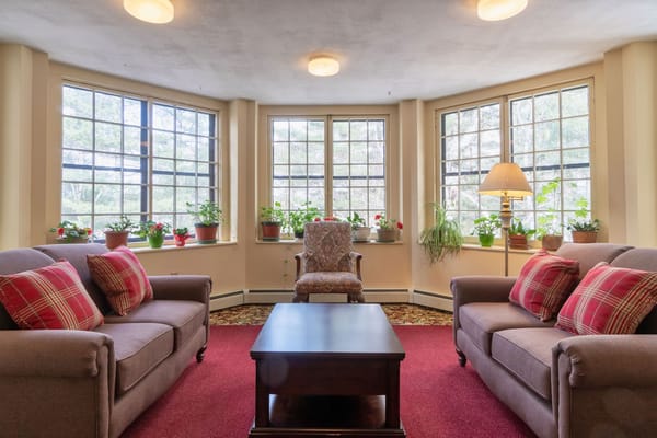 Bright common area with comfortable seating and plants
