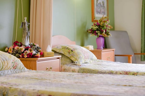 Cozy resident room with two beds and floral decor