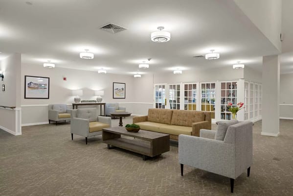 Bright and spacious living room with seating areas and decor