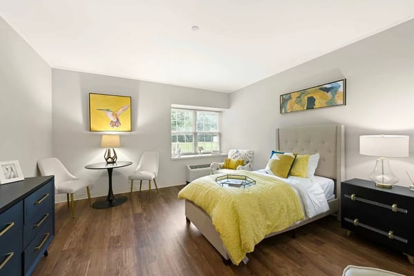 Bright bedroom with yellow accents and comfortable furniture