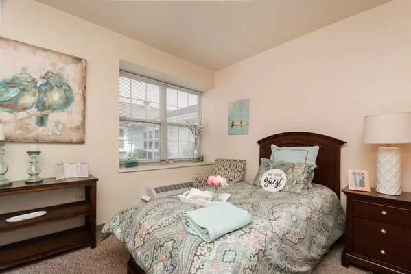 Interior view of a cozy bedroom with a bed and decorative items