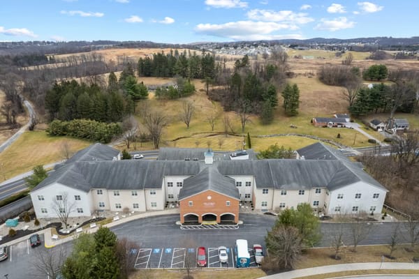 Aerial view of Seaton Springwood senior living facility surrounded by green landscape.