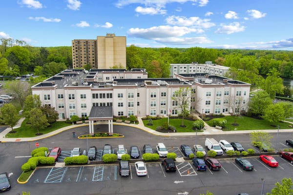 Aerial view of the facility with parking lot and greenery