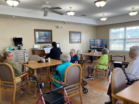 Seniors engaged in a social activity in the common room of Serenity South.