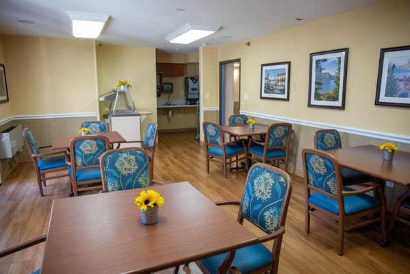 Bright dining area with floral centerpieces and seating