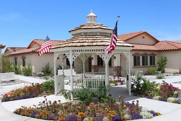Gazebo surrounded by colorful flowers and American flags