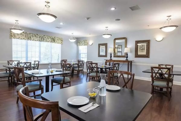 Bright dining room with tables set and food visible