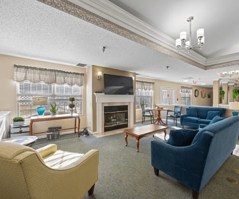 Lounge with seating and a fireplace at Summit Place Assisted Living