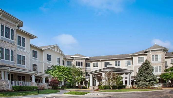 Exterior view of a senior living facility surrounded by greenery