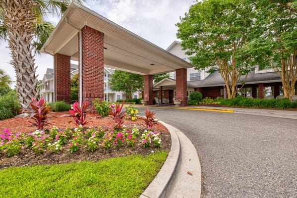 Entrance with brick pillars and colorful flowers at TerraBella Myrtle Beach.
