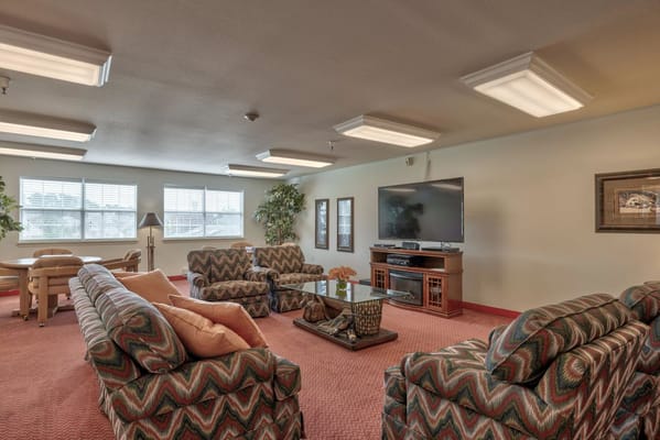 Cozy lounge area with patterned sofas and a TV