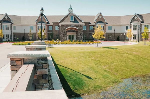 Exterior view of a senior living facility with landscaped grounds