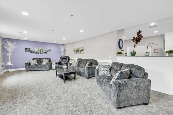 Cozy lounge seating with gray sofas and a coffee table.