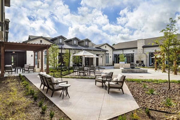 Outdoor courtyard with seating and landscaping at The Landing at Augusta Woods