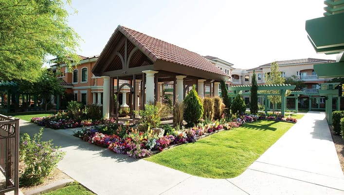 Pathway lined with flowers leading to a gazebo