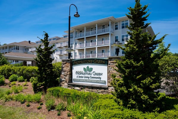 Exterior view of Village at Proprietors Green facility with sign