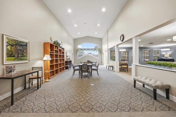 Spacious common area with seating and bookshelf