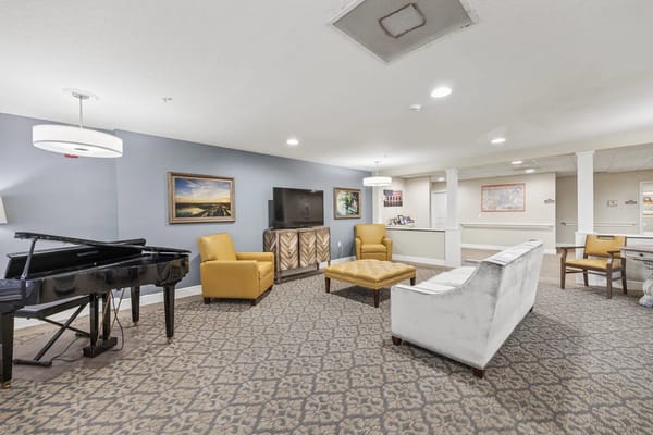 Cozy common area with piano, seating, and artwork