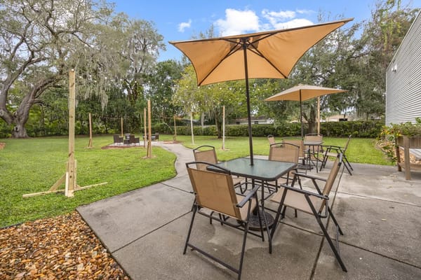 Outdoor seating with umbrellas in a green area