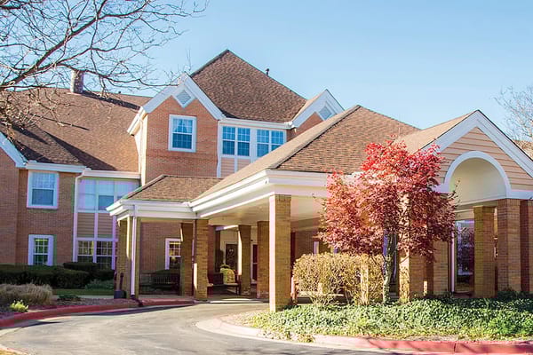 Front entrance of a senior living facility with landscaping.