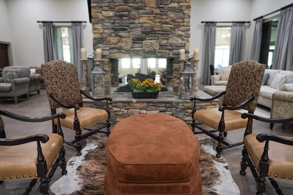 Cozy common area with chairs and fireplace