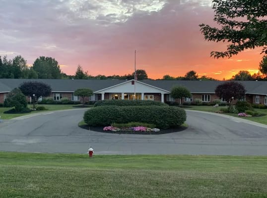 Exterior view of Elderwood Village at Colonie during sunset