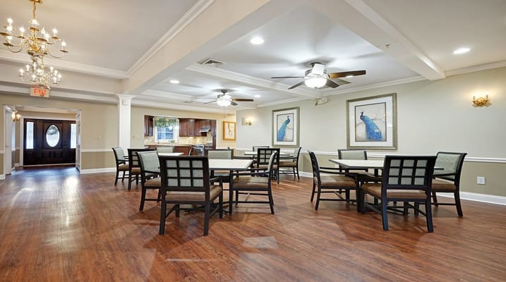 Dining room setup with tables and peacock artwork