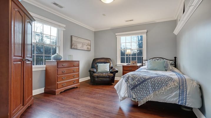 Cozy private resident room with a bed and furniture